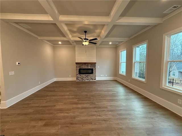 unfurnished living room featuring hardwood / wood-style flooring, coffered ceiling, a fireplace, and beam ceiling