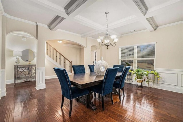 dining space with arched walkways, beam ceiling, and hardwood / wood-style flooring