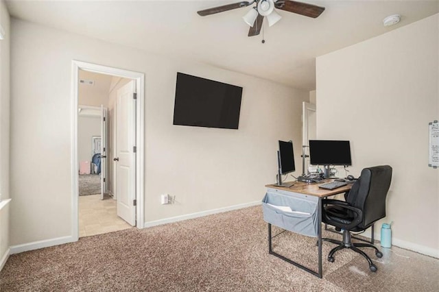 carpeted office with baseboards and a ceiling fan