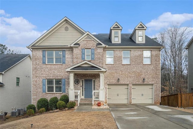 view of front of home featuring an attached garage, fence, concrete driveway, and brick siding