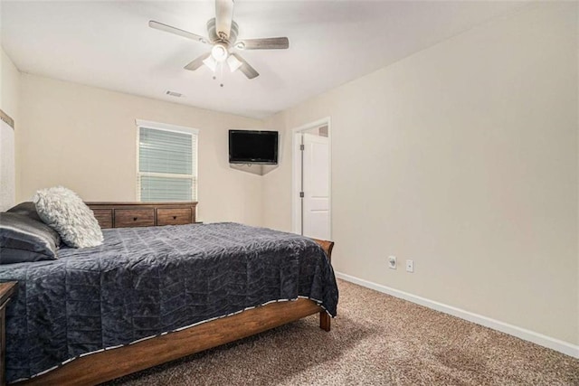 carpeted bedroom with a ceiling fan, visible vents, and baseboards