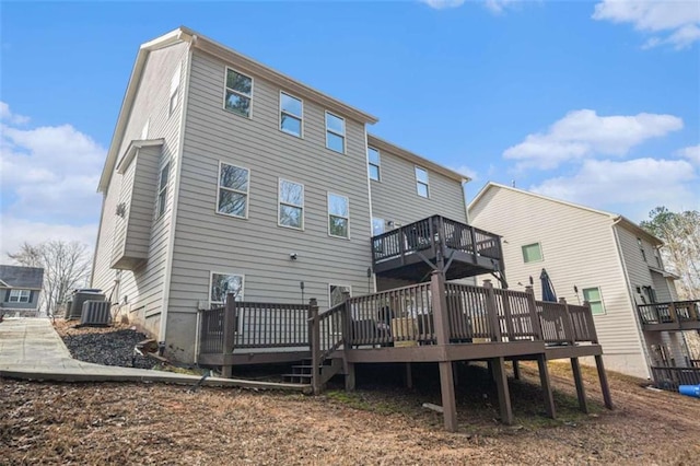 rear view of property with central AC and a wooden deck