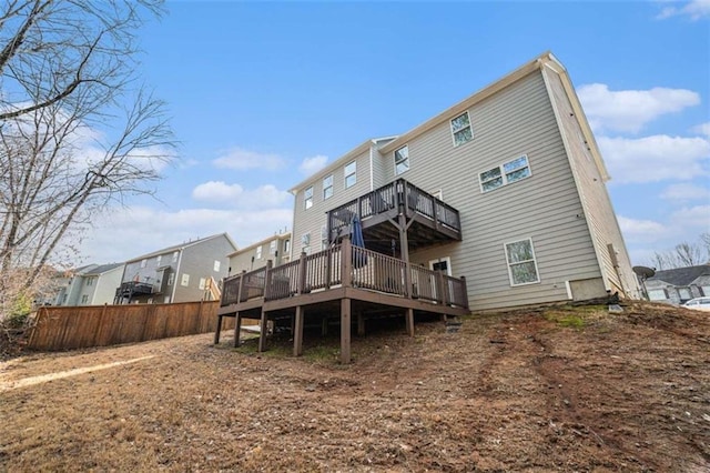 back of house with a wooden deck and fence