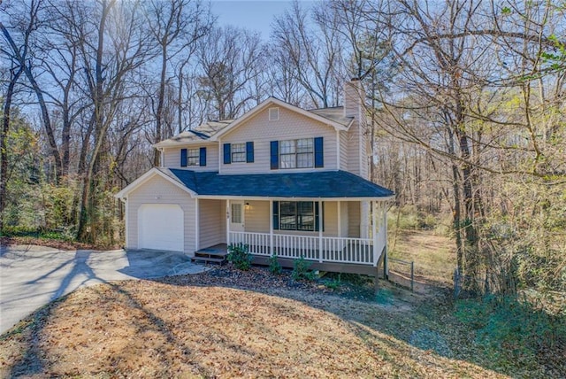 view of property with a garage and a porch