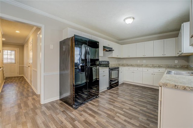 kitchen with sink, ornamental molding, black appliances, and white cabinets