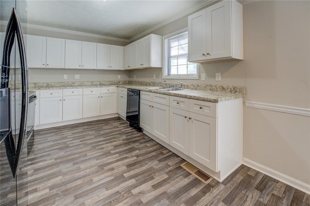 kitchen with sink, white cabinetry, crown molding, black appliances, and hardwood / wood-style flooring