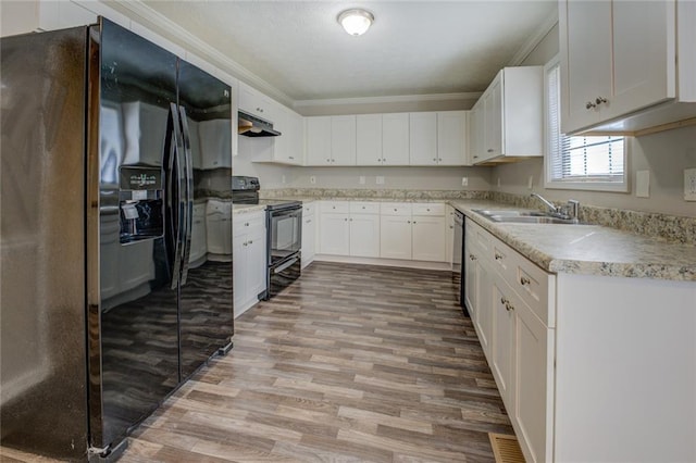 kitchen featuring sink, ornamental molding, black appliances, and white cabinets