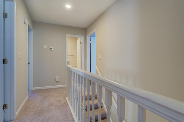 hall featuring light colored carpet