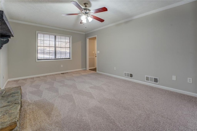 carpeted spare room with a textured ceiling, ceiling fan, and ornamental molding