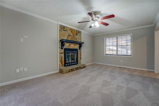 unfurnished living room featuring a fireplace, a textured ceiling, crown molding, and light colored carpet