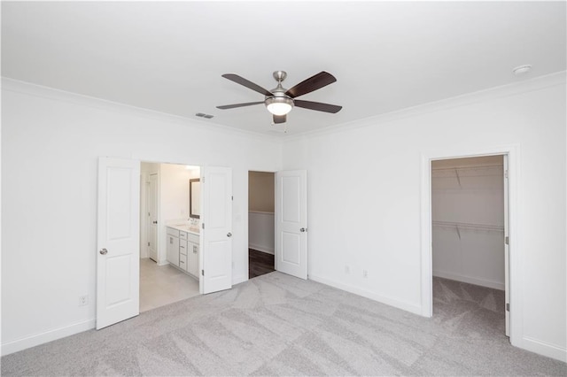 5448 Howington Ct E Unit 194, Buford, GA 30518 - unfurnished bedroom featuring a walk in closet, crown molding, light carpet, baseboards, and a closet
