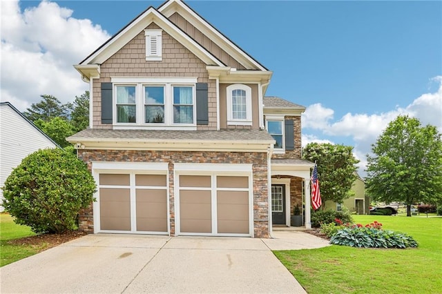 5225 Stonehaven Vw, Cumming, GA 30040 - craftsman house with driveway, an attached garage, a front lawn, stone siding, and a shingled roof