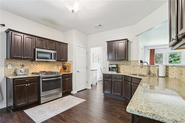 5225 Stonehaven Vw, Cumming, GA 30040 - kitchen with stainless steel appliances, a sink, dark brown cabinets, and dark wood-style floors