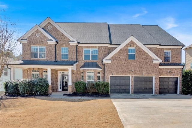 view of front of house with a front yard, an attached garage, brick siding, and driveway