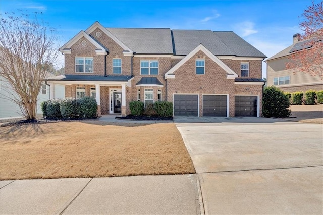 view of front of house featuring concrete driveway, brick siding, a garage, and a front lawn