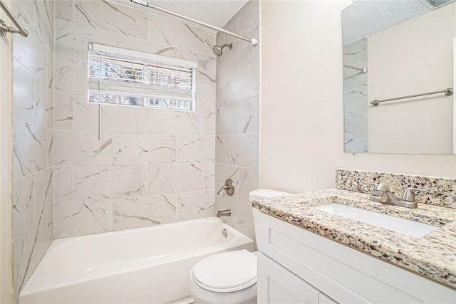 full bathroom with tiled shower / bath combo, toilet, a textured ceiling, and vanity