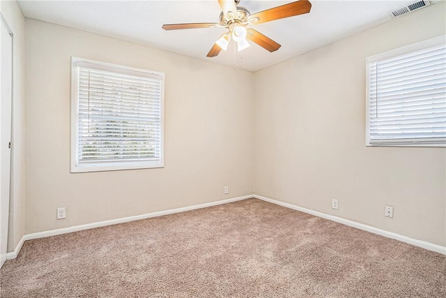 carpeted empty room featuring ceiling fan