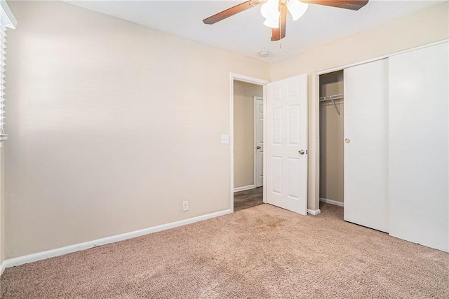 unfurnished bedroom with ceiling fan, a closet, and light carpet