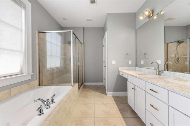 bathroom with shower with separate bathtub, vanity, and tile patterned floors