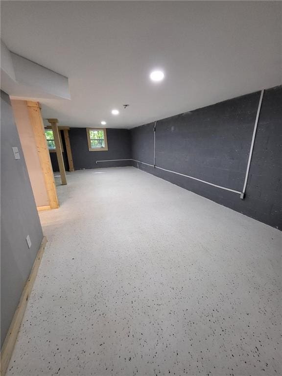 basement with baseboards and recessed lighting