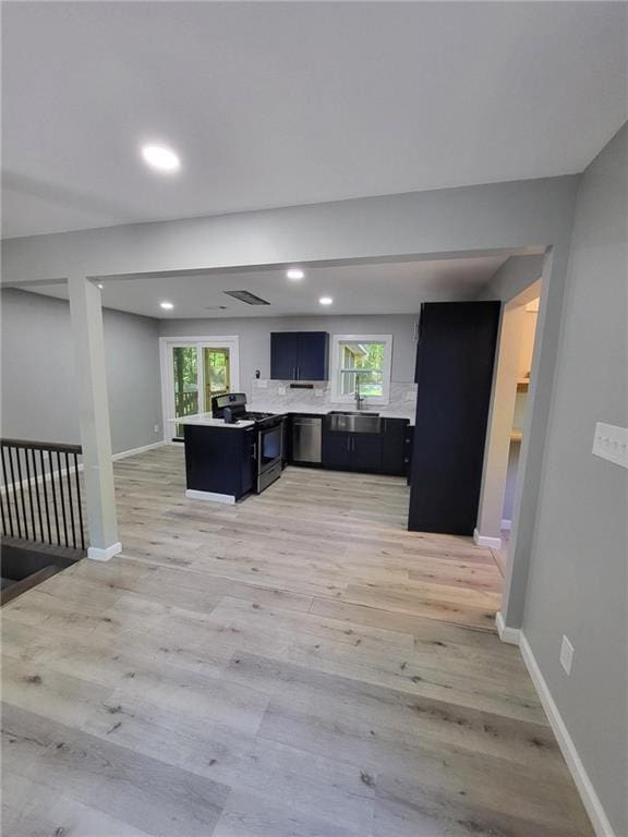 living room with baseboards, a wealth of natural light, light wood-style flooring, and recessed lighting