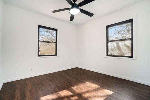 unfurnished room featuring ceiling fan, dark hardwood / wood-style flooring, and a wealth of natural light