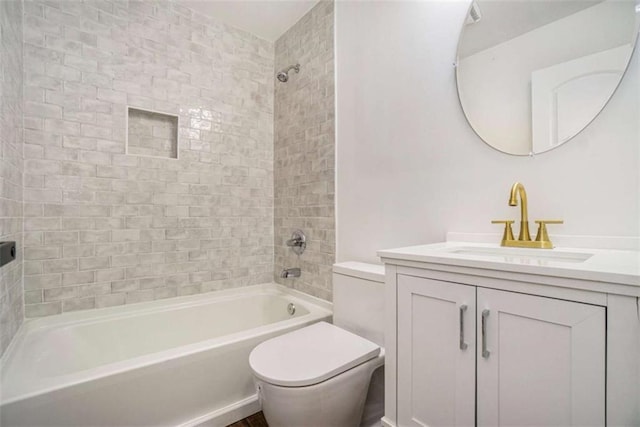 full bathroom with tiled shower / bath, vanity, and toilet