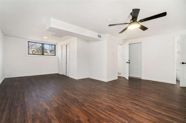 empty room with dark wood-type flooring and ceiling fan