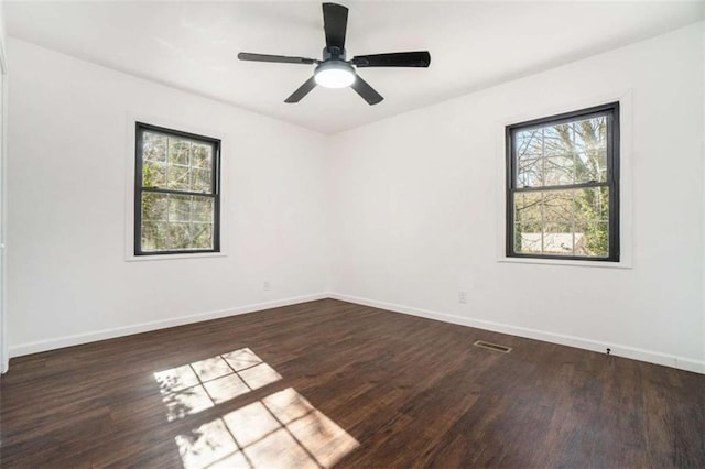 unfurnished room featuring dark wood-type flooring and ceiling fan