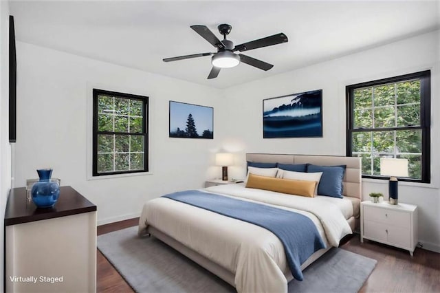 bedroom with dark hardwood / wood-style floors and ceiling fan