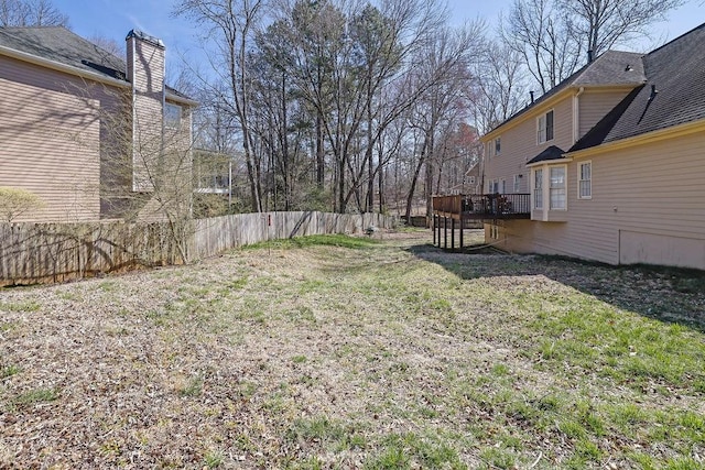 view of yard with a deck and fence