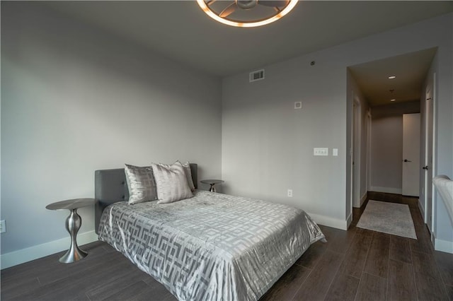 bedroom with dark hardwood / wood-style flooring