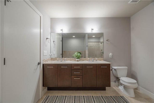 bathroom featuring an enclosed shower, vanity, decorative backsplash, tile patterned floors, and toilet