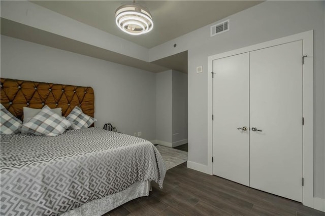 bedroom featuring dark hardwood / wood-style flooring and a closet