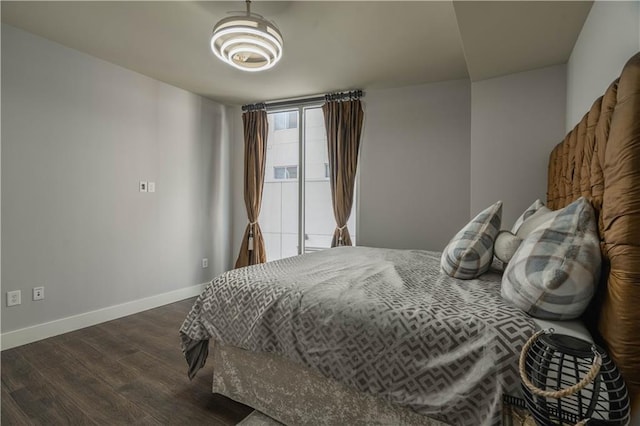 bedroom with dark hardwood / wood-style flooring