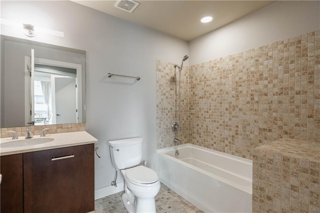 full bathroom with vanity, toilet, tiled shower / bath combo, and tile patterned flooring