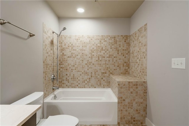 full bathroom with tiled shower / bath combo, vanity, and toilet