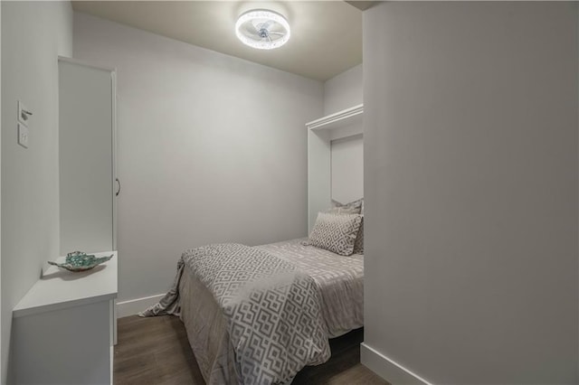 bedroom with dark hardwood / wood-style floors