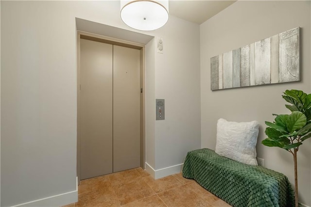 mudroom with elevator and light tile patterned floors