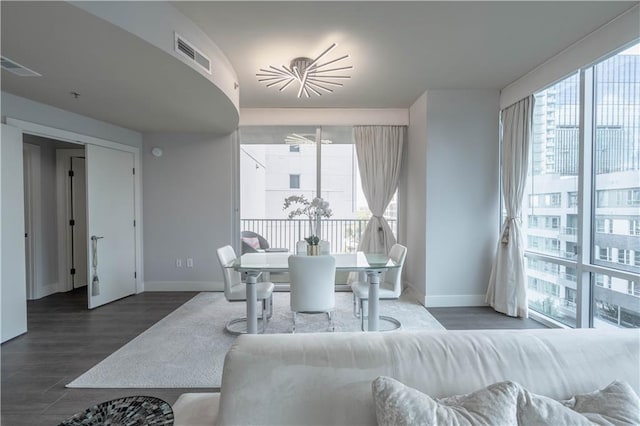 dining area featuring dark hardwood / wood-style flooring and a healthy amount of sunlight