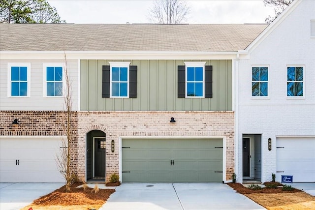 multi unit property featuring brick siding, board and batten siding, and driveway