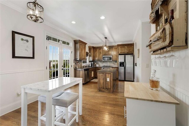 735 Neel Reid Dr, Roswell, GA 30075 - kitchen with french doors, ornamental molding, appliances with stainless steel finishes, and a kitchen island