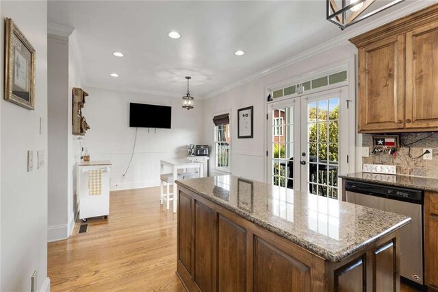 735 Neel Reid Dr, Roswell, GA 30075 - kitchen featuring stainless steel dishwasher, crown molding, a kitchen island, light wood finished floors, and french doors