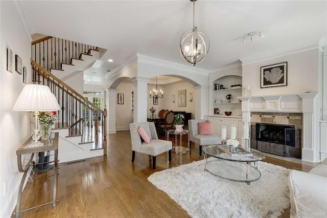 735 Neel Reid Dr, Roswell, GA 30075 - living area featuring a chandelier, arched walkways, stairs, and crown molding