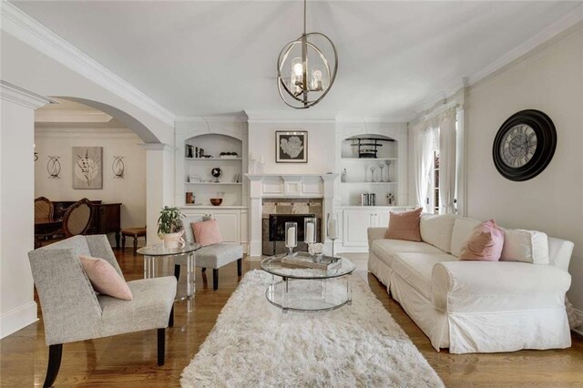 735 Neel Reid Dr, Roswell, GA 30075 - living area featuring ornamental molding, arched walkways, wood finished floors, and a chandelier