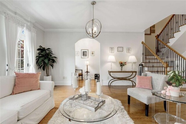 735 Neel Reid Dr, Roswell, GA 30075 - living area featuring a chandelier, wood finished floors, arched walkways, and stairs
