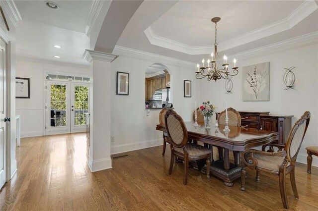 735 Neel Reid Dr, Roswell, GA 30075 - dining room with arched walkways, wood finished floors, a chandelier, ornamental molding, and french doors
