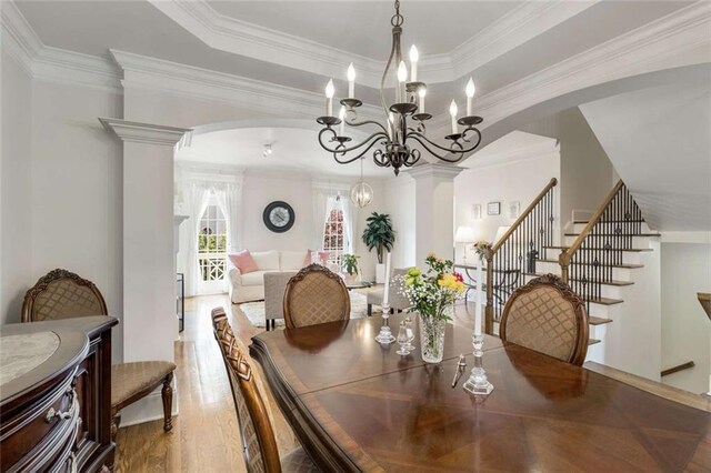 735 Neel Reid Dr, Roswell, GA 30075 - dining room with arched walkways, wood finished floors, a chandelier, stairway, and crown molding