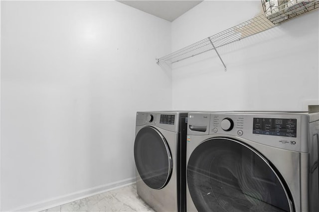 clothes washing area featuring separate washer and dryer