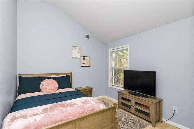 carpeted bedroom with vaulted ceiling